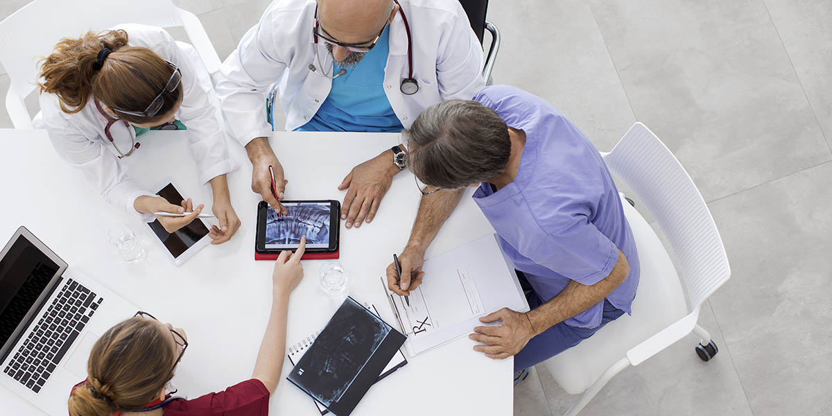 Medical team sitting and discussing at table